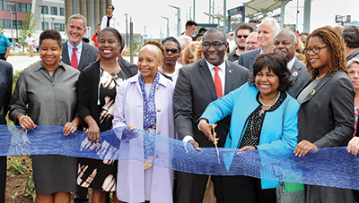 City of St. Louis Comptroller Darlene Green, second from right, cuts the ribbon to officially open the new Cortex MetroLink station, as representatives of partners in the project, including BJC HealthCare’s June McAllister Fowler, left, and Bob Cannon, second from left, look on.