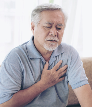 Asian man with heartburn