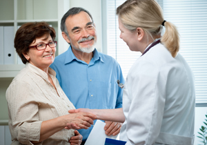 couple conferring with female doctor